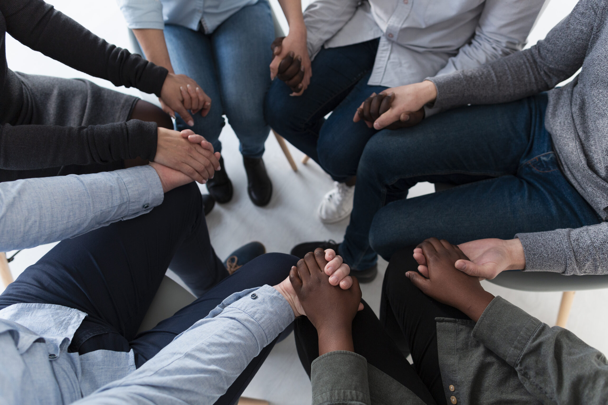 top-view-patients-standing-circle-holding-hands